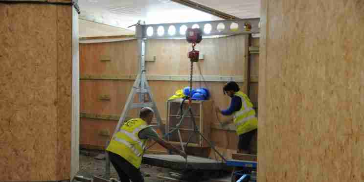 Workers lowering ledgerstone onto Abbey floor, as part of Footprint project